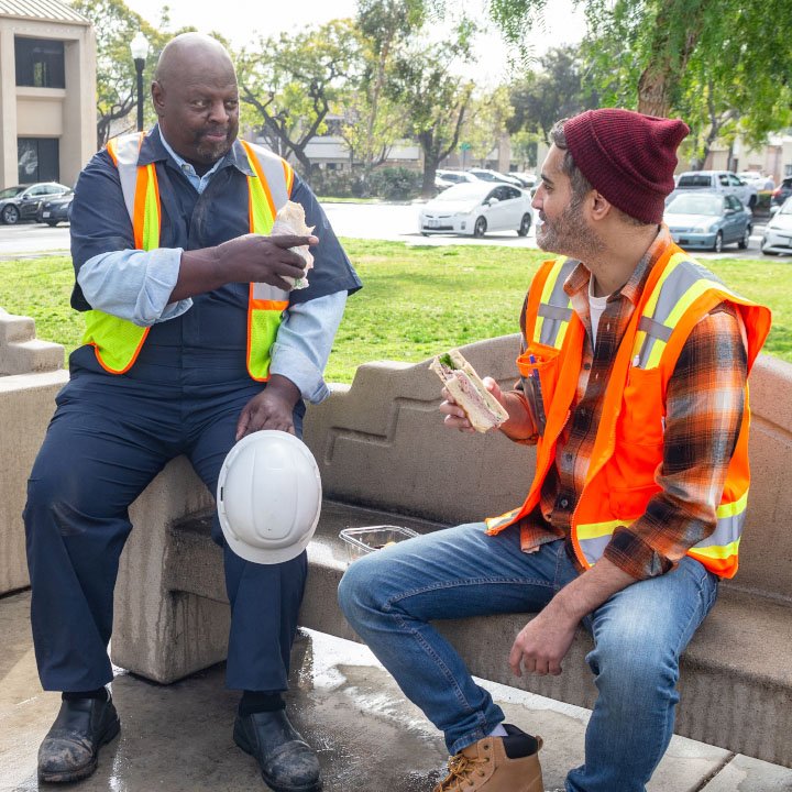 Two constructions workers on lunch break are better protected by TruStage AD&D Insurance.
