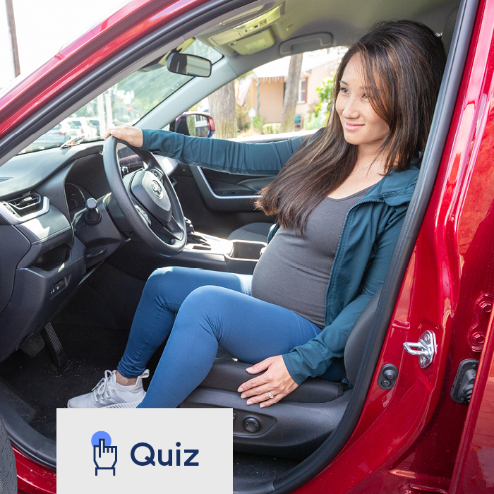 Pregnant woman getting out of her car