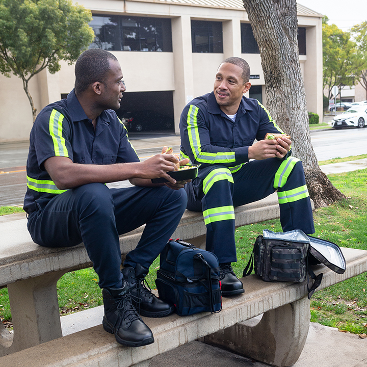 Hard-working EMTs discuss life insurance vs accidental death and dismemberment on their lunch break outdoors